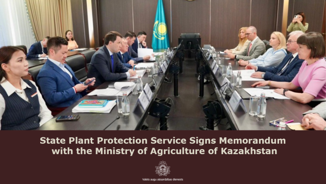 Representatives of the Latvian delegation are seated together around a table in the conference room of the Ministry of Agriculture of Kazakhstan.