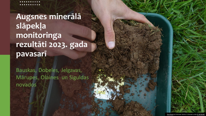 Augsnes traukā un rokas, fonā lauks, pa virsu virsraksta teksts 